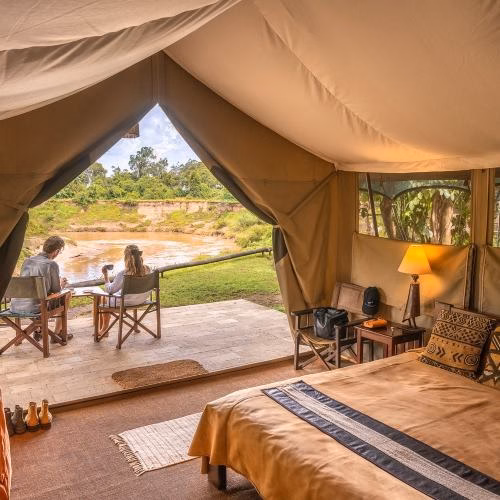 relaxing by the pool in governors camp in masai mara
